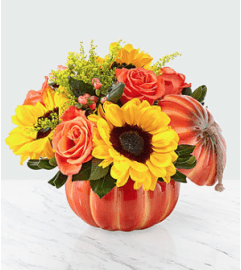 Bountiful Bouquet in a Ceramic Pumpkin. An arrangement by Palmetto Gardens Florist.