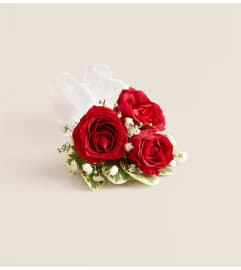 Red Spray Rose Corsage. An arrangement by Flowers of Jacksonville.