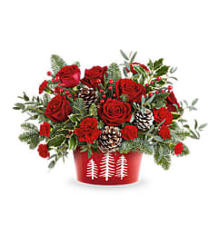 The Teleflora's Winter Whimsy Centerpiece. An arrangement by Marivel's Florist and Gifts.