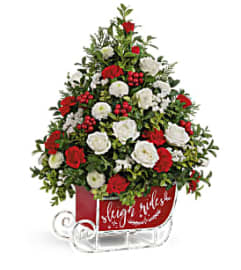 Teleflora's Festive Sleigh Tree Bouquet. An arrangement by Margaret's Florist.