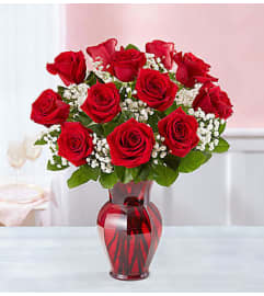 Blooming Love™ Red Roses in Red Vase. An arrangement by Flowers of Jacksonville.