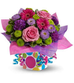 Teleflora's Confetti Present. An arrangement by Pompano Beach Floral.