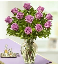 Purple Roses in Clear Vase. An arrangement by Blessing and Blooms Florist.