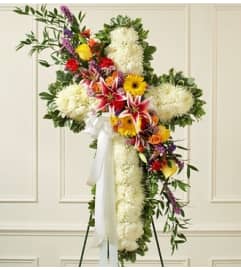 White Standing Cross with Bright Flower Break. An arrangement by Blessing and Blooms Florist.