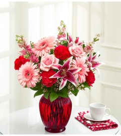 For All She Does™ in a Red Vase. An arrangement by Blessing and Blooms Florist.