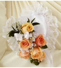 Peach and White Satin Heart Casket Pillow. An arrangement by Blessing and Blooms Florist.