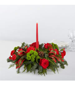 By the Candlelight Centerpiece Teleflora. An arrangement by Country Cousins Flower Shop.
