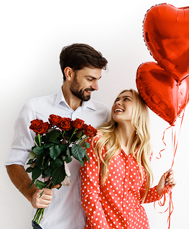 A couple with the man holding flowers and girl holding balloons A couple with the man holding flowers and girl holding balloons