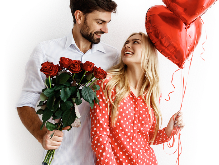 A couple with the man holding flowers and girl holding balloons A couple with the man holding flowers and girl holding balloons