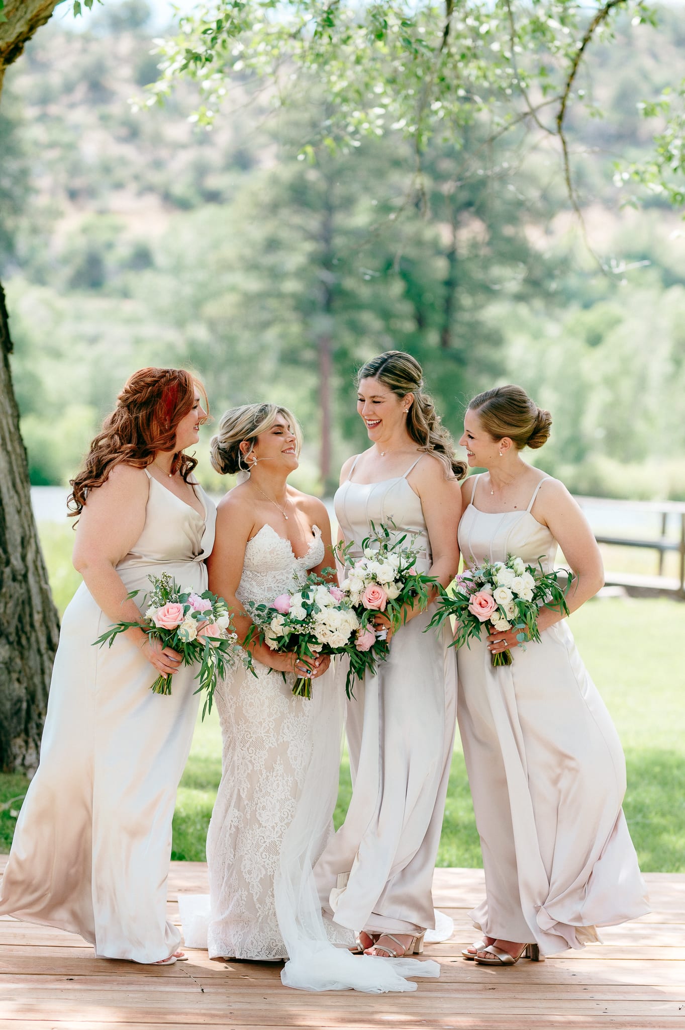 Bride with bridesmaids and pastel wedding bouquets in Bayfield CO