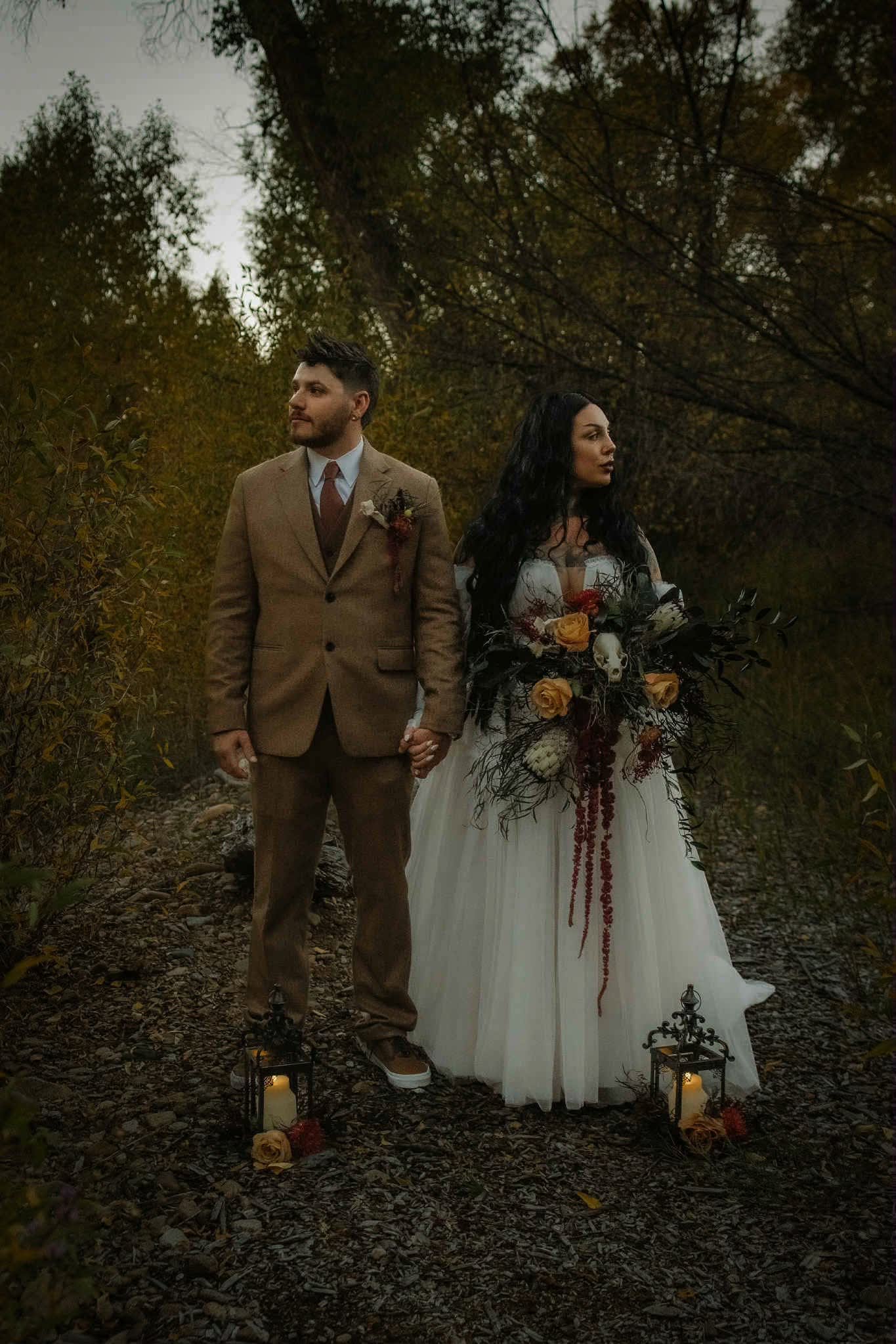 Bride and groom with lanterns and wedding flowers in Bayfield CO