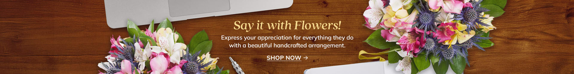 Multicolor flower bouquet on a desk with laptop and notebook - flower delivery in Centretown, Ottawa