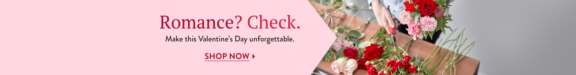 A florist creating a Valentine's Day arrangement with pink elements - flower delivery in Snohomish County, Snohomish