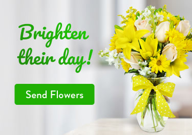 Flower arrangement of yellow lilies and daisies on a table - flower delivery in Garfield