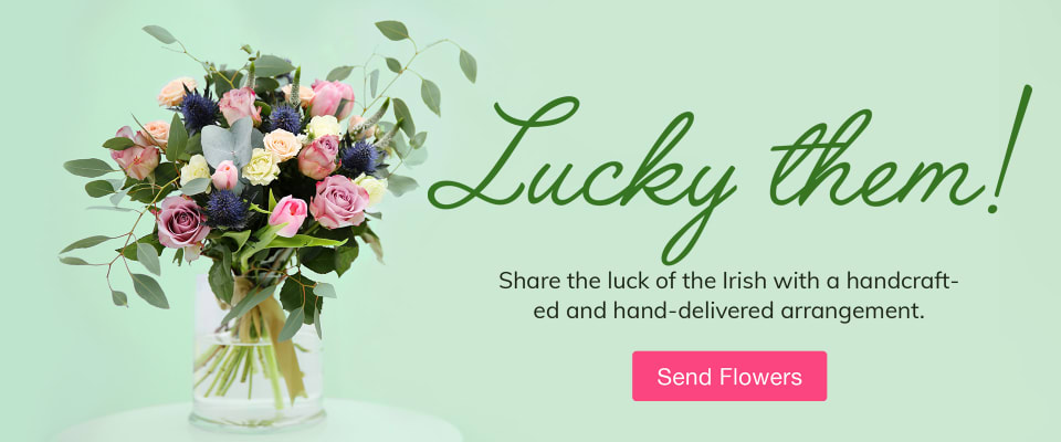 Decorations and four leaf clovers on a green background to celebrate St. Patrick's Day - flower delivery in Garfield
