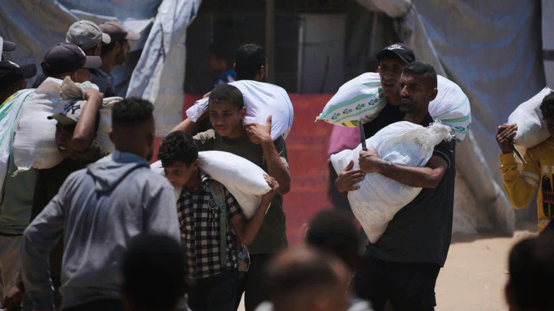 Gaza aid distributed by trucks for the first time amid gunfire and casualties.