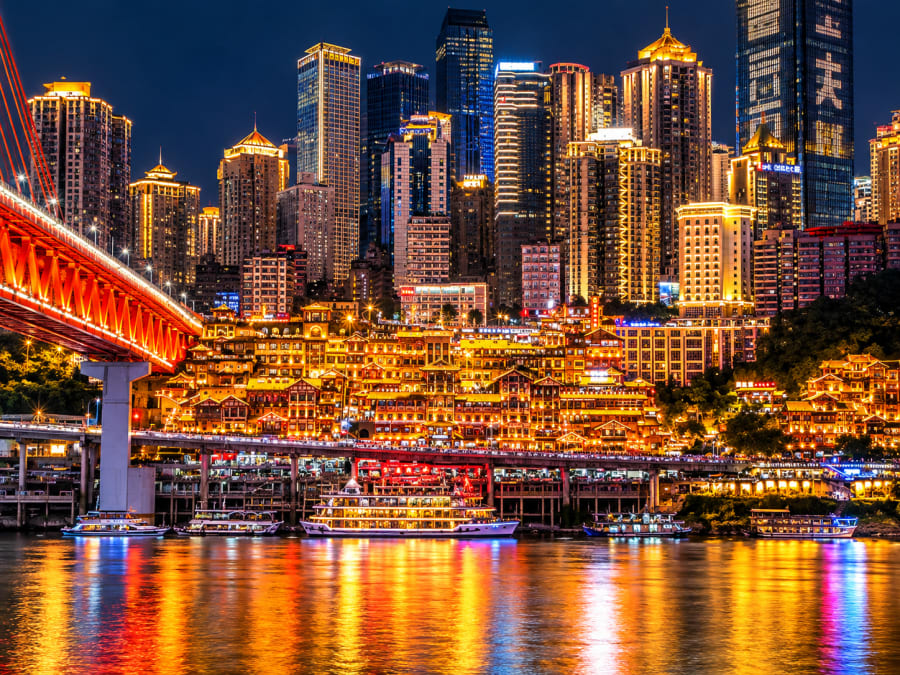 Experience Chongqing's illuminated Hongyadong complex after sunset.