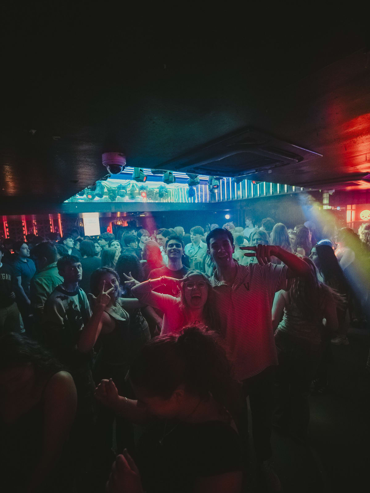 Packed dancefloor under blue and red lights at Latin Fest
