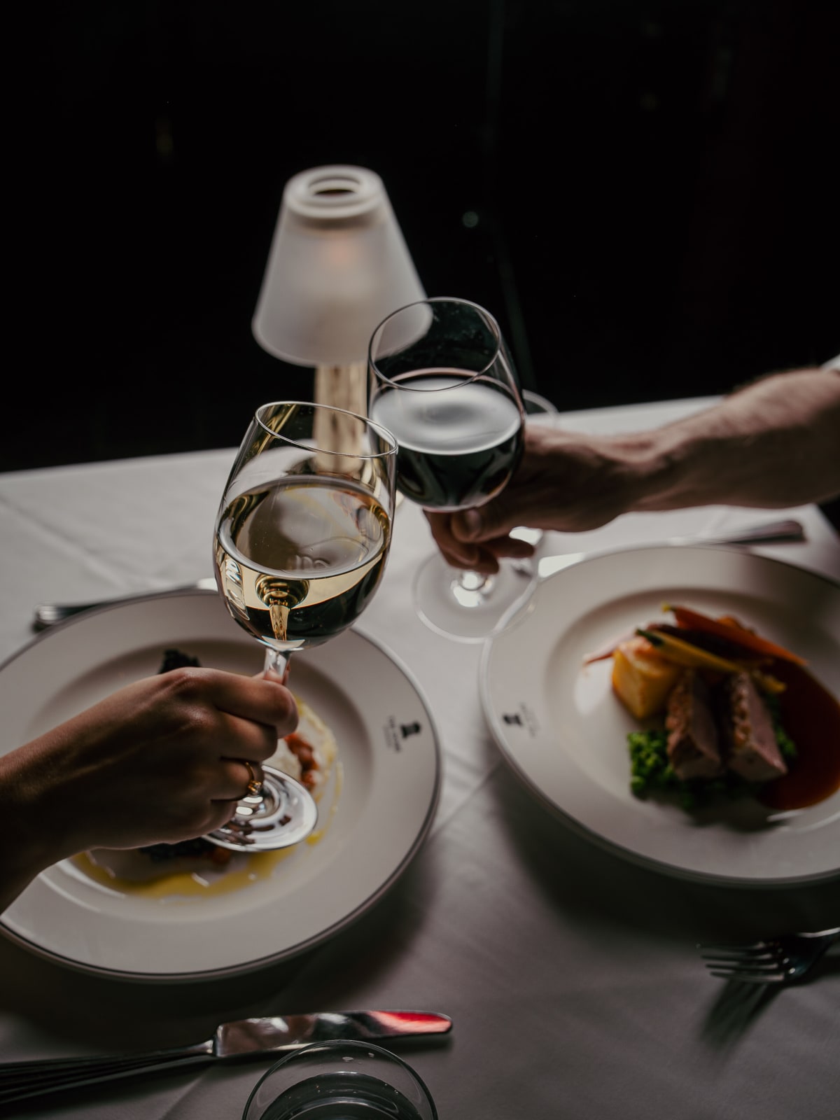 Guests toasting with wine over dinner at The Dome, Edinburgh