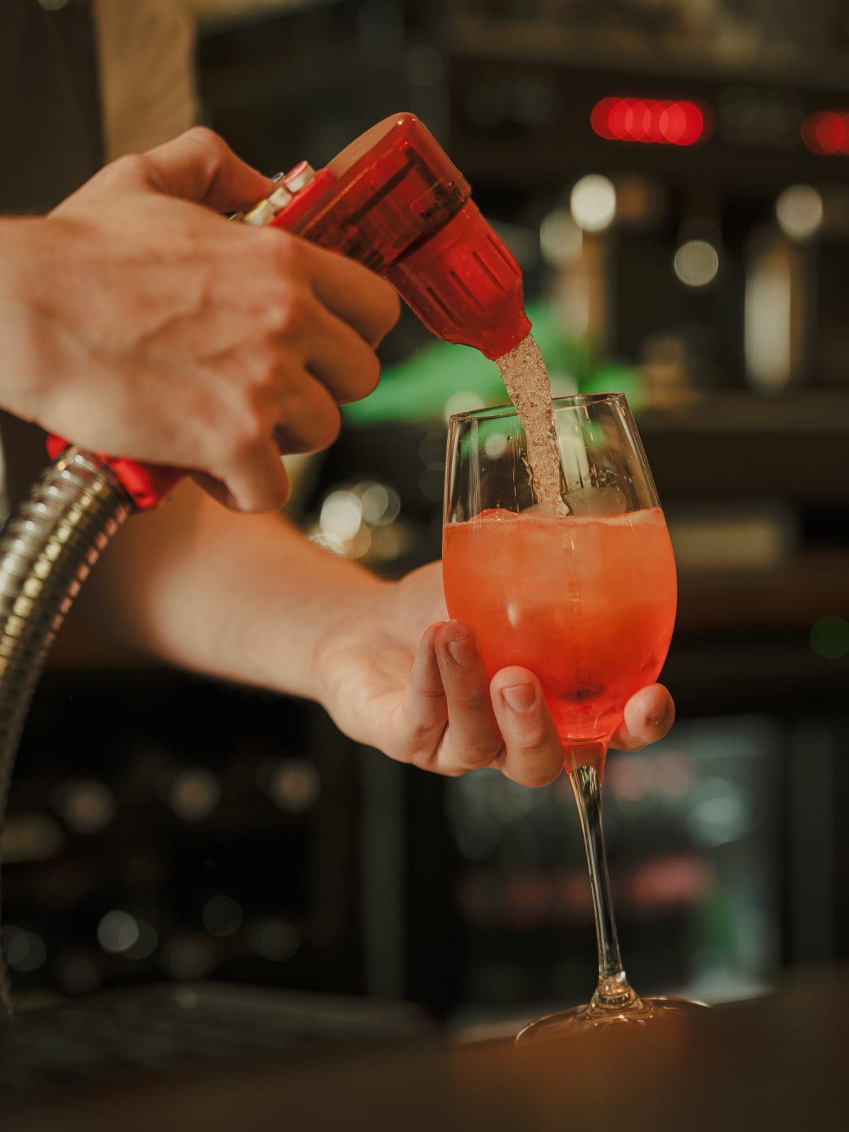 Bartender caramelising an orange slice with a blowtorch over a spritz at The Winton