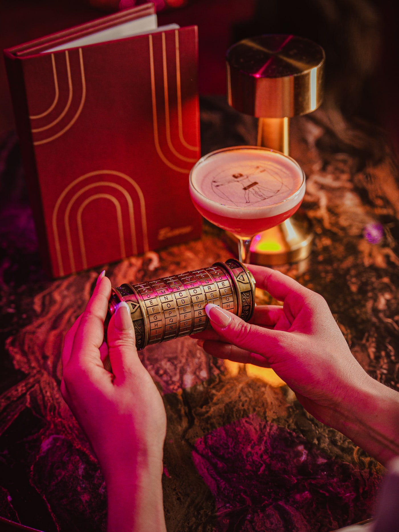 Bartender shaking a cocktail beside the drinks menu at Encore