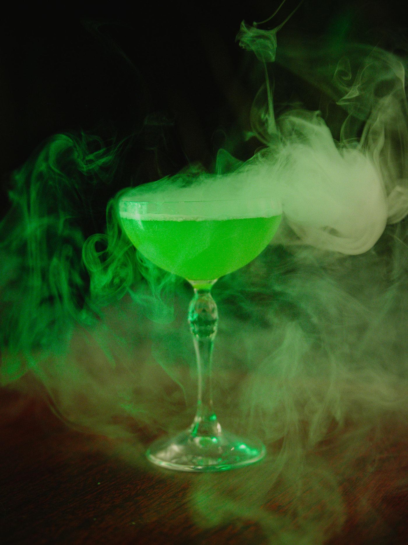 The Dragon: green cocktail wrapped in smoke at Jackson The Tailor
