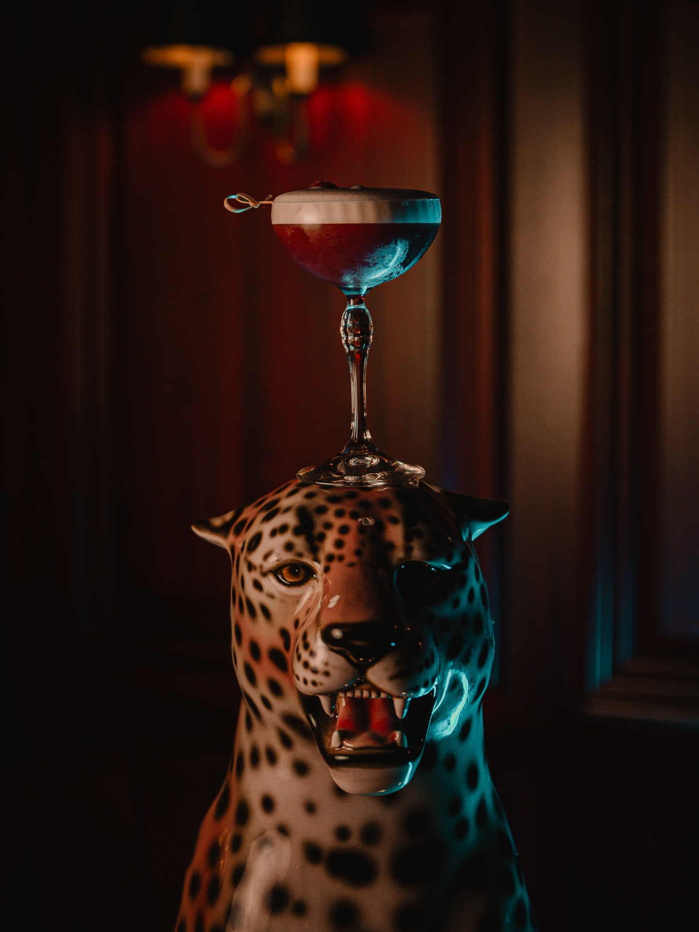 The Dragon cocktail beside the leopard statue at Jackson The Tailor