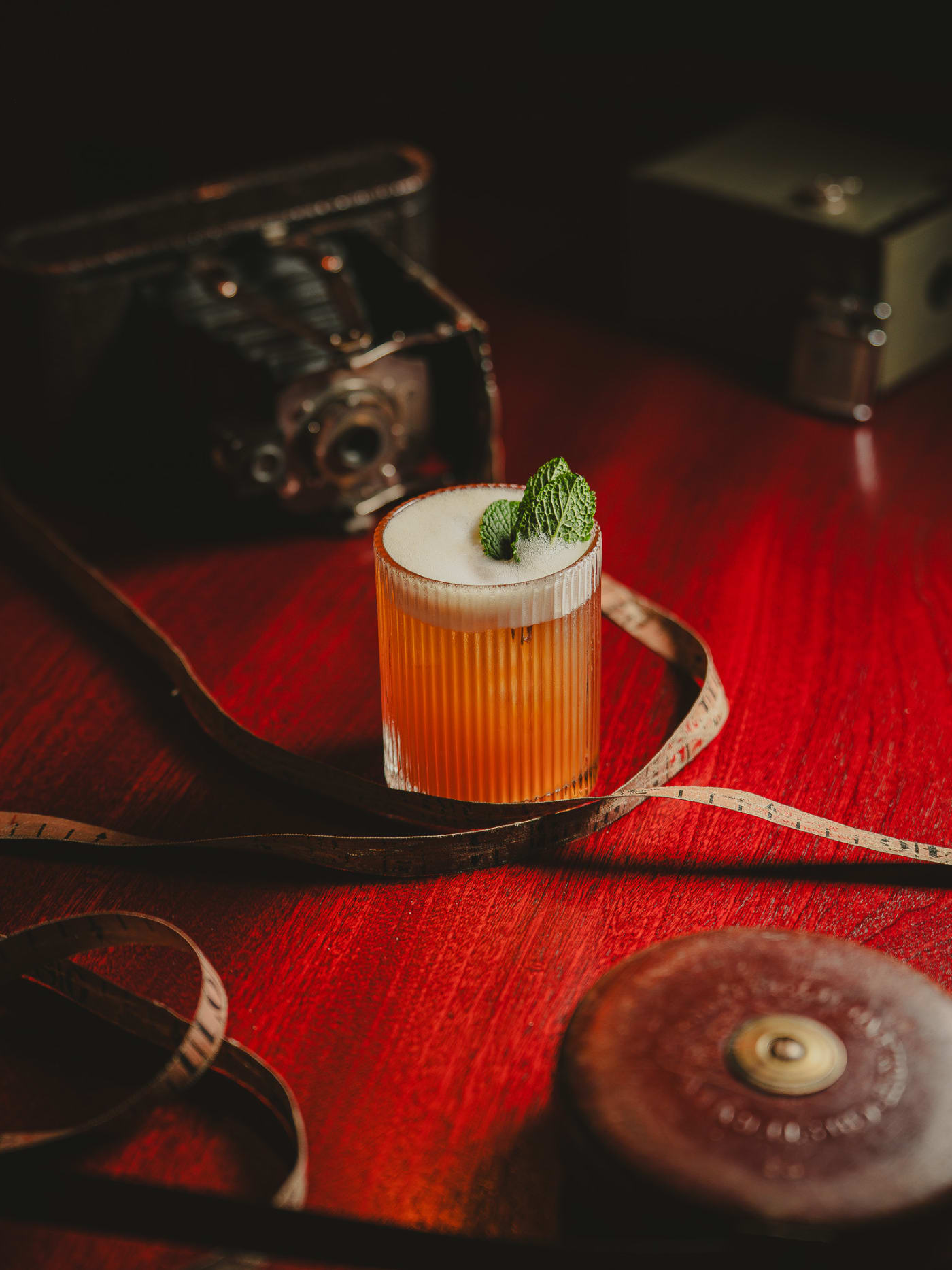 Amber sour with a tailor’s tape and a vintage camera at Jackson The Tailor