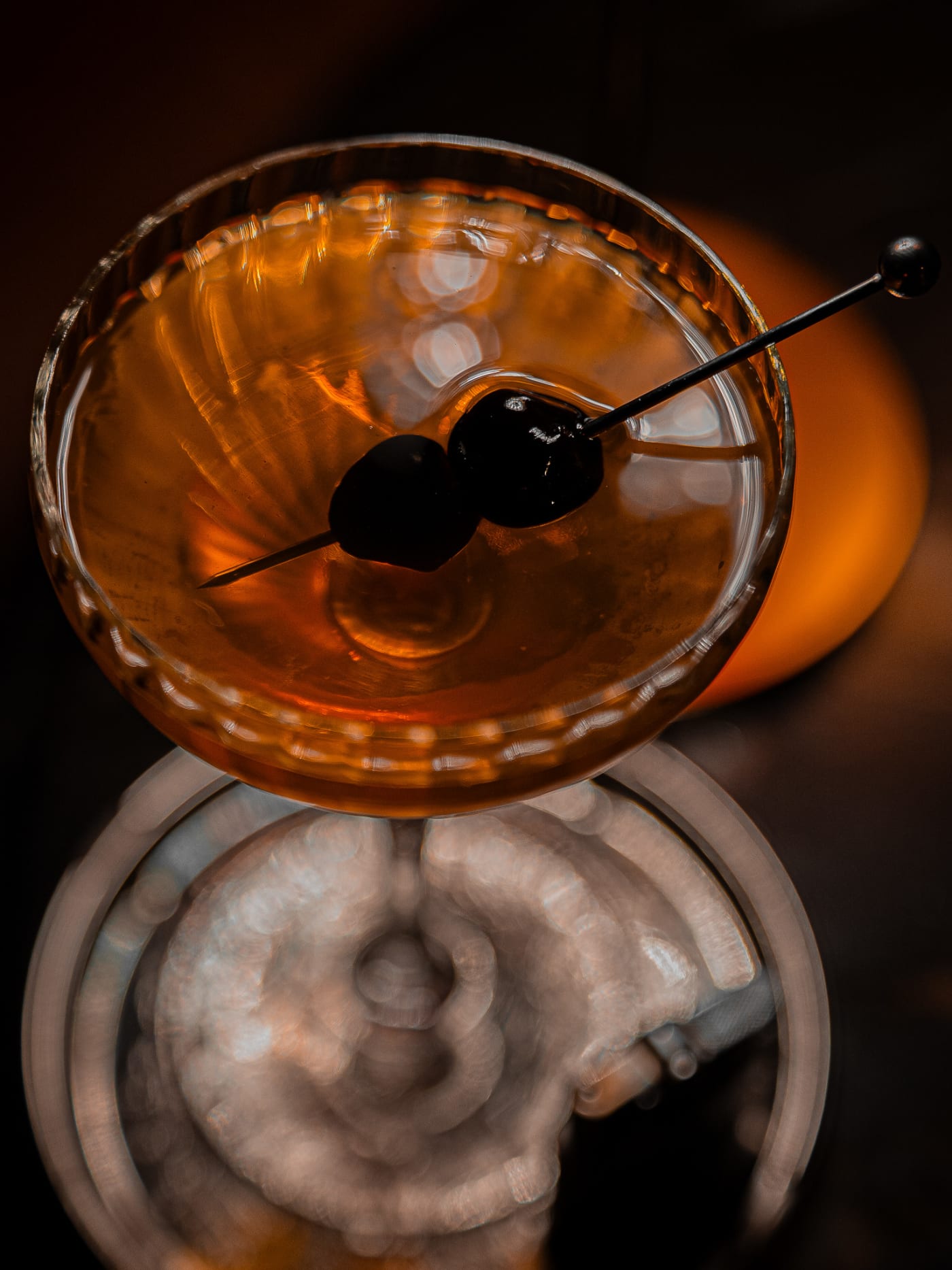 Manhattan with cherries on an engraved silver tray at Jackson The Tailor