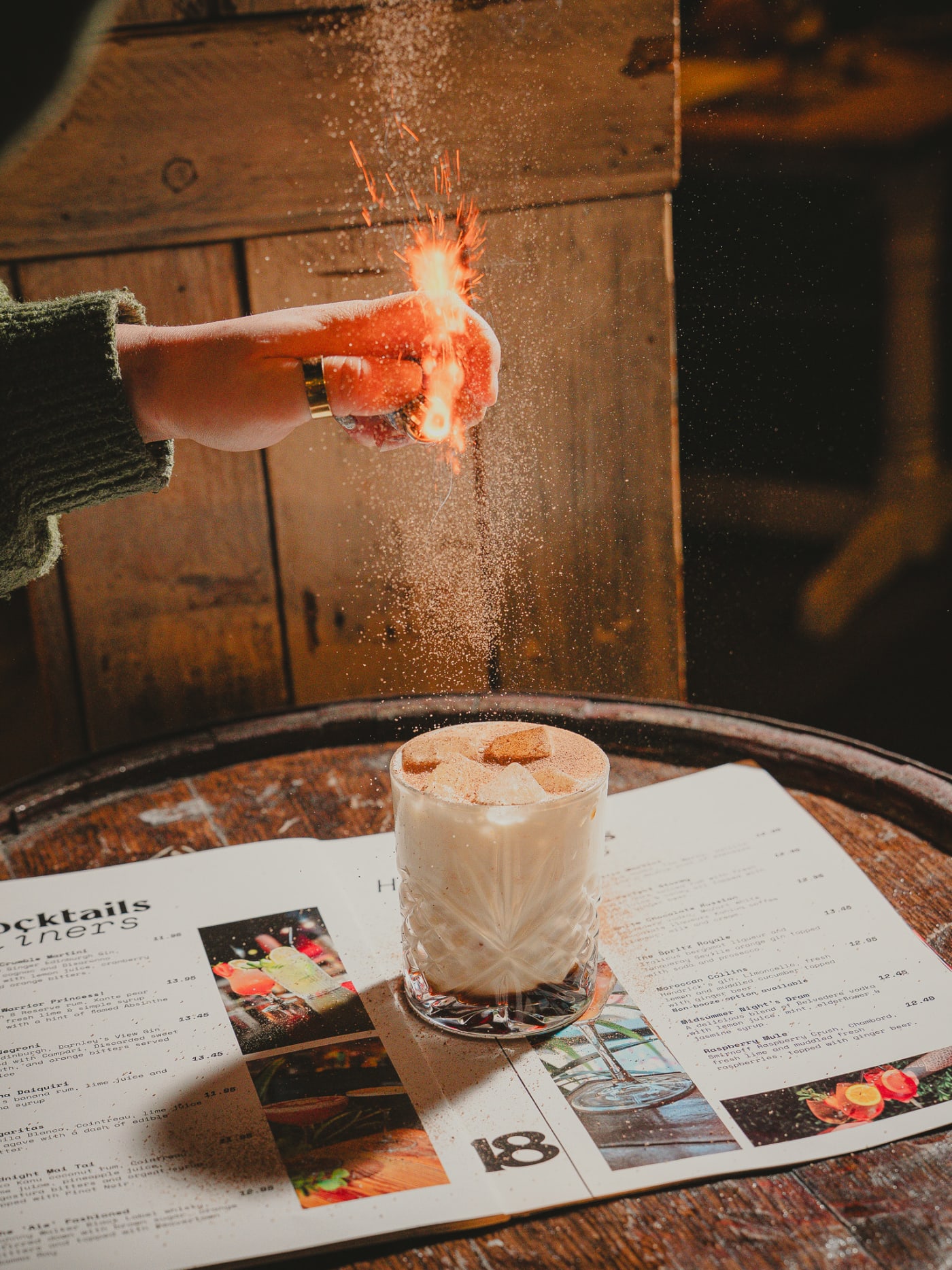 Smoked cocktail being torched on a whisky barrel at Newsroom Edinburgh