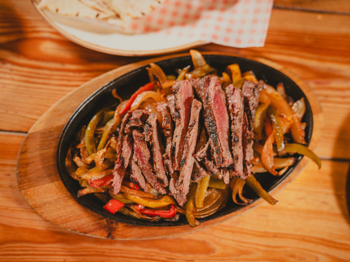 Sizzling steak fajitas skillet at Newsroom bar and eatery