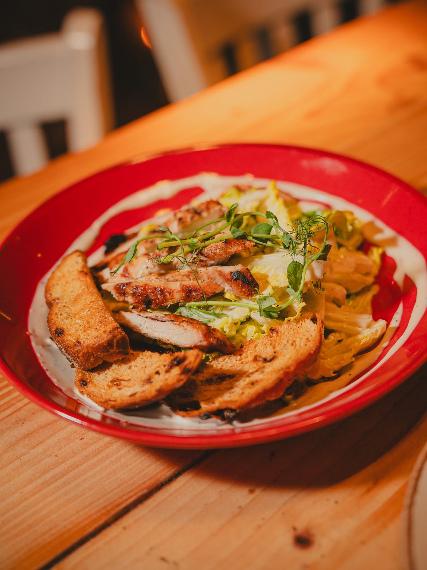Chicken schnitzel on a red plate at Newsroom Edinburgh