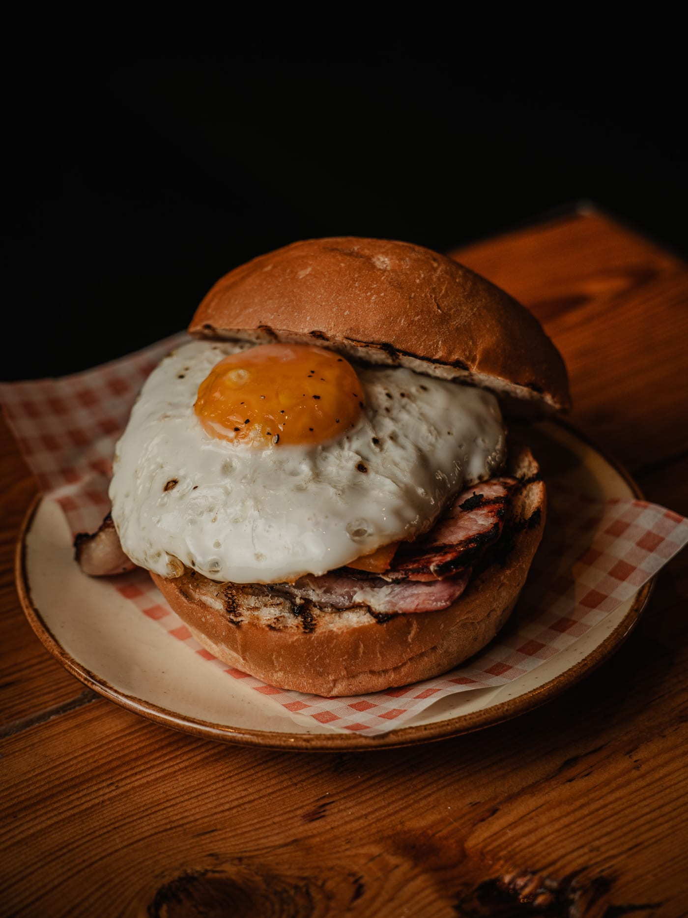 Breakfast burger topped with a fried egg at Newsroom