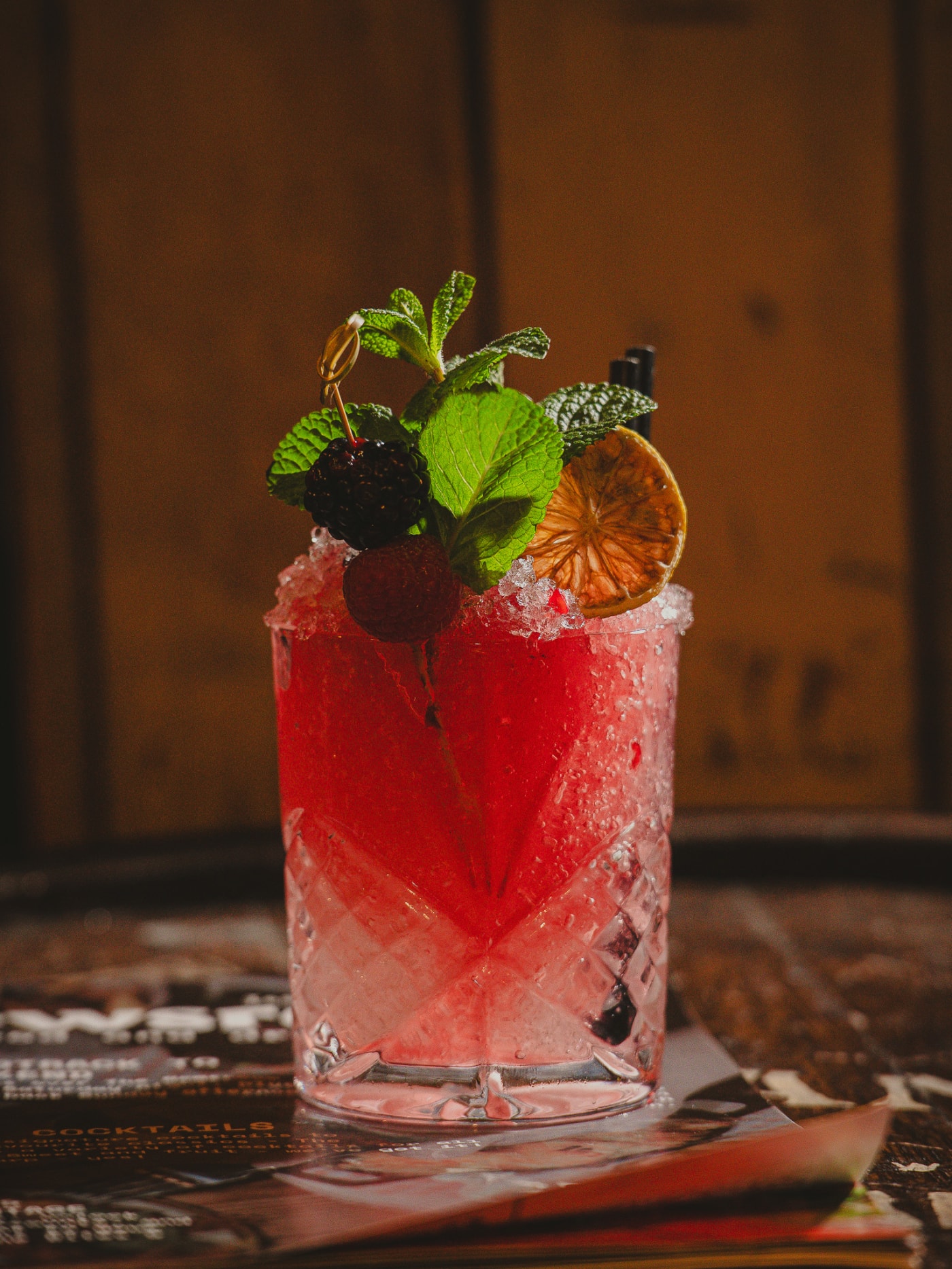 Berry cocktail over crushed ice garnished with mint, blackberry and dried orange at Newsroom, Edinburgh