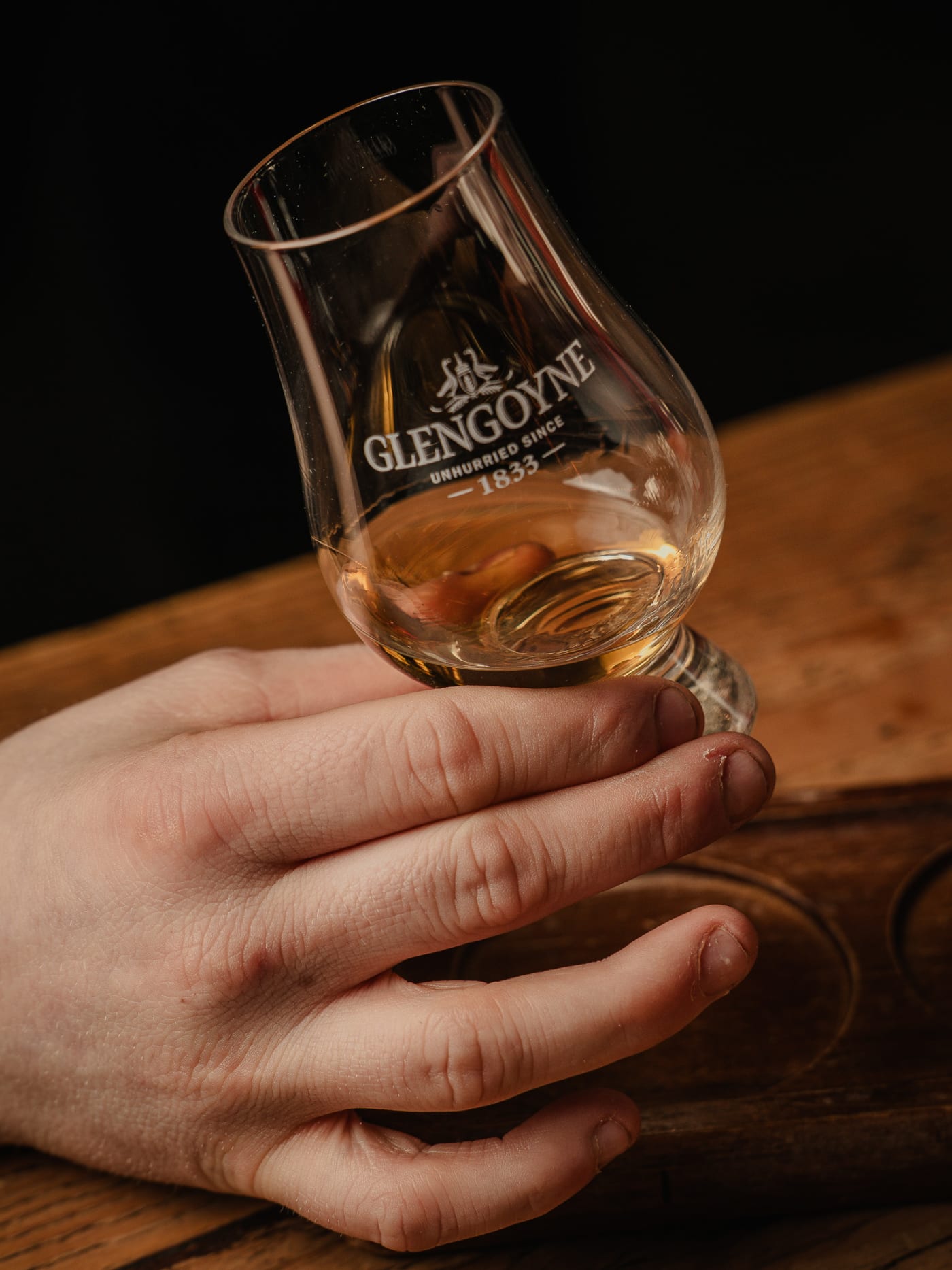Hand nosing a Glencairn glass of single malt whisky during a tasting at Newsroom, Edinburgh