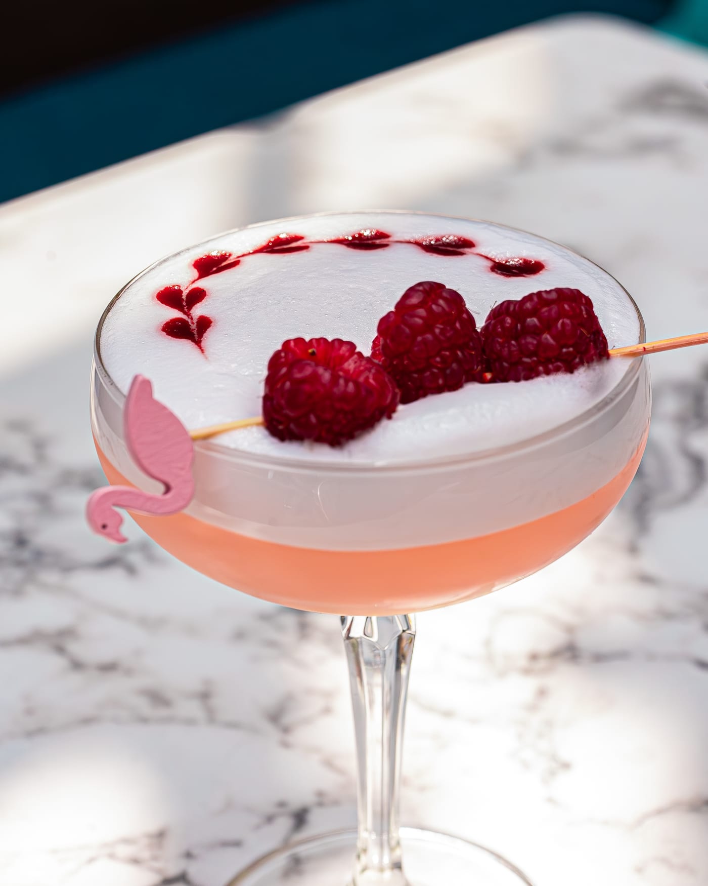 Raspberry-topped sour on a marble table at Rose Street Garden, Edinburgh
