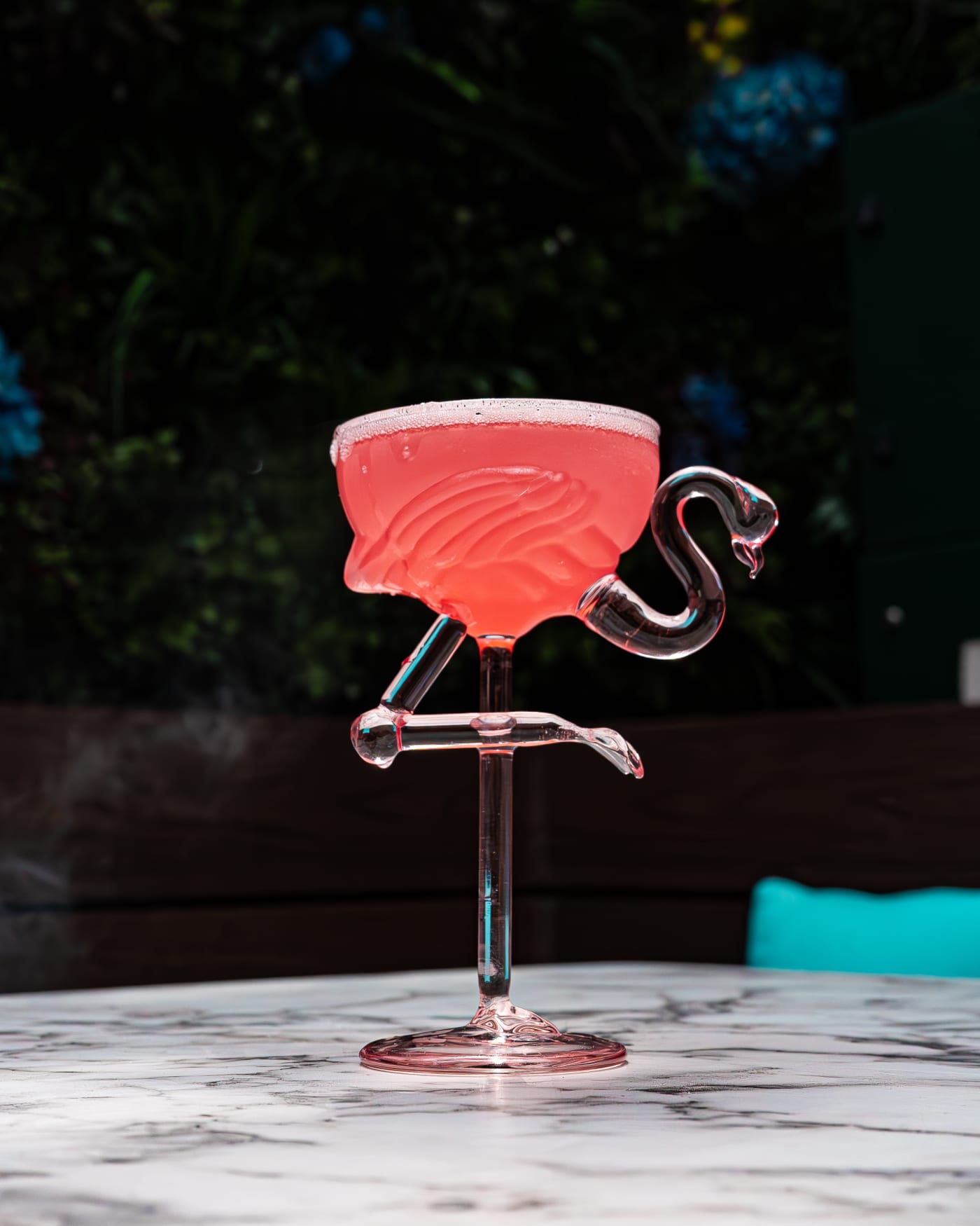 Pink cocktail in a flamingo glass at Rose Street Garden, Edinburgh