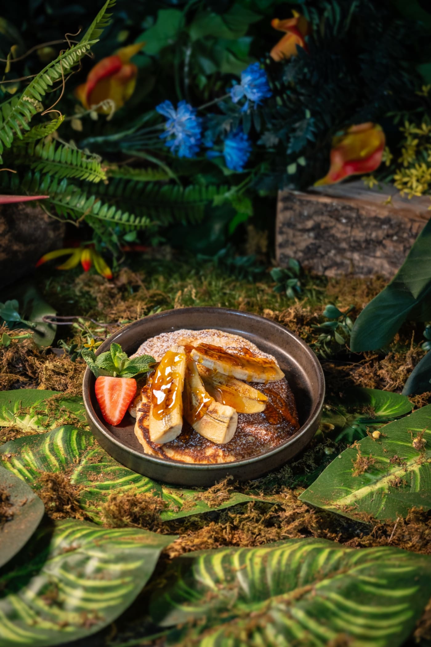 Pancakes with strawberries on the jungle-themed set at Rose Street Garden, Edinburgh