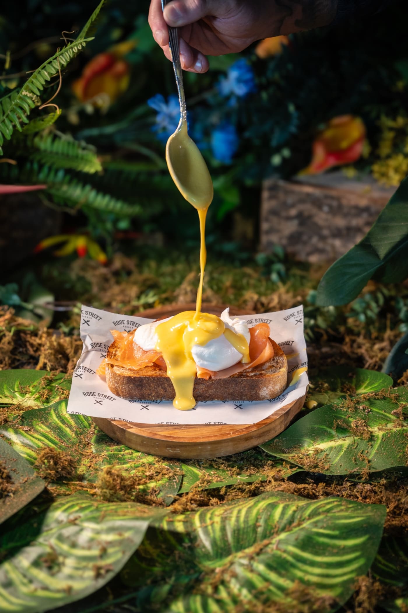 Hollandaise poured over eggs Benedict at Rose Street Garden, Edinburgh