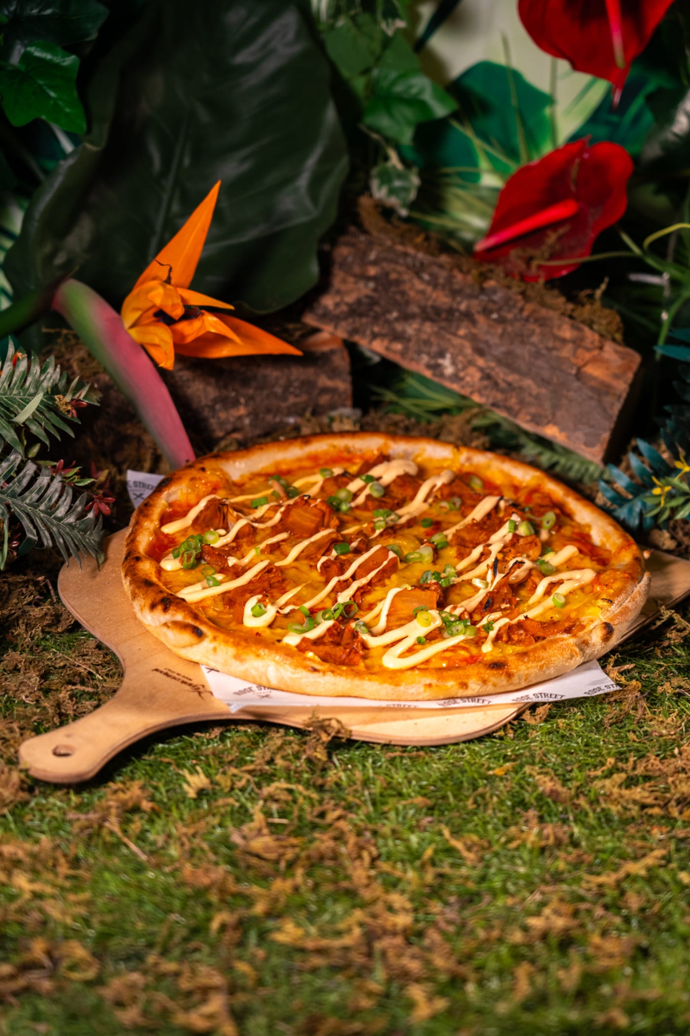 Wood-fired pizza on a serving paddle at Rose Street Garden, Edinburgh