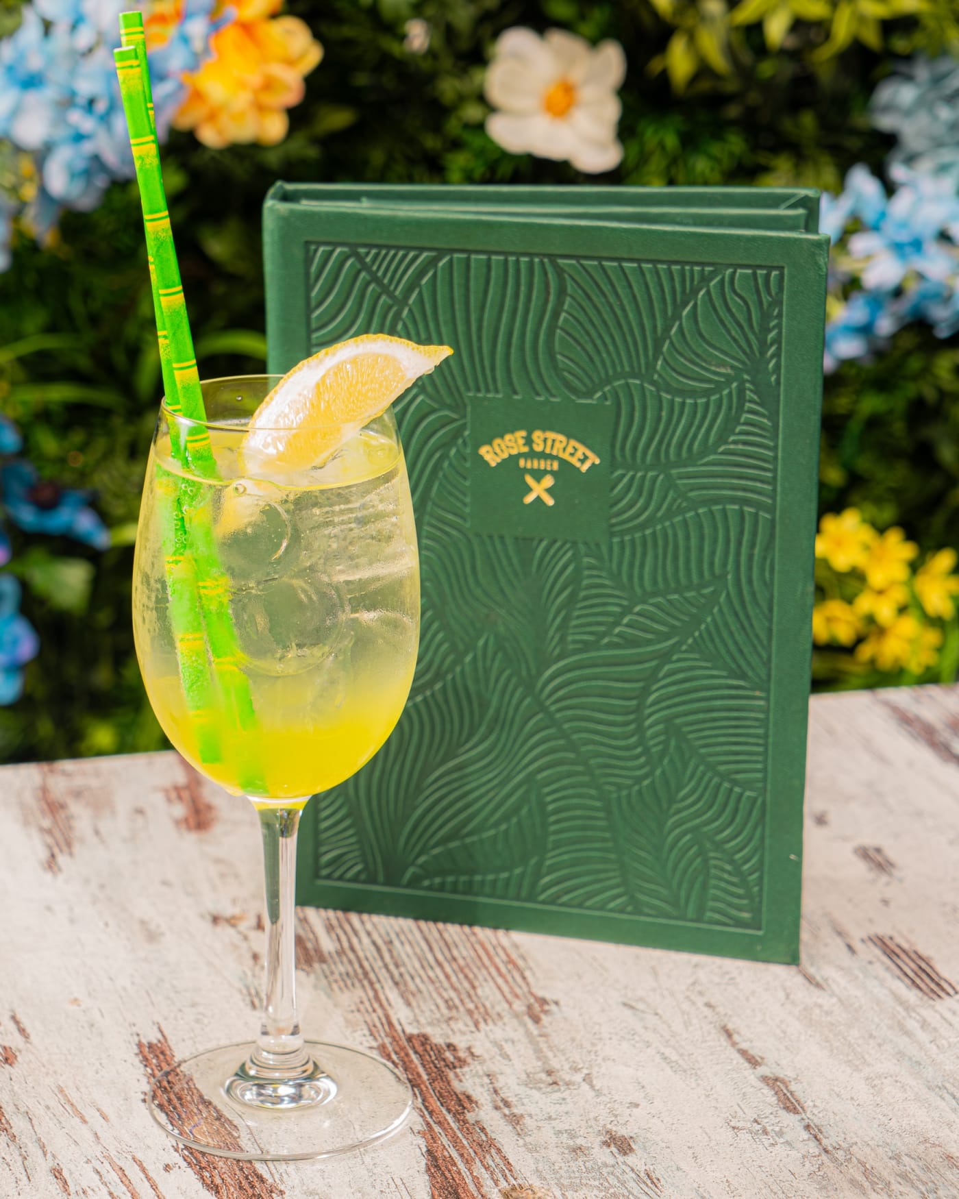Lemon spritz beside the embossed menu at Rose Street Garden, Edinburgh
