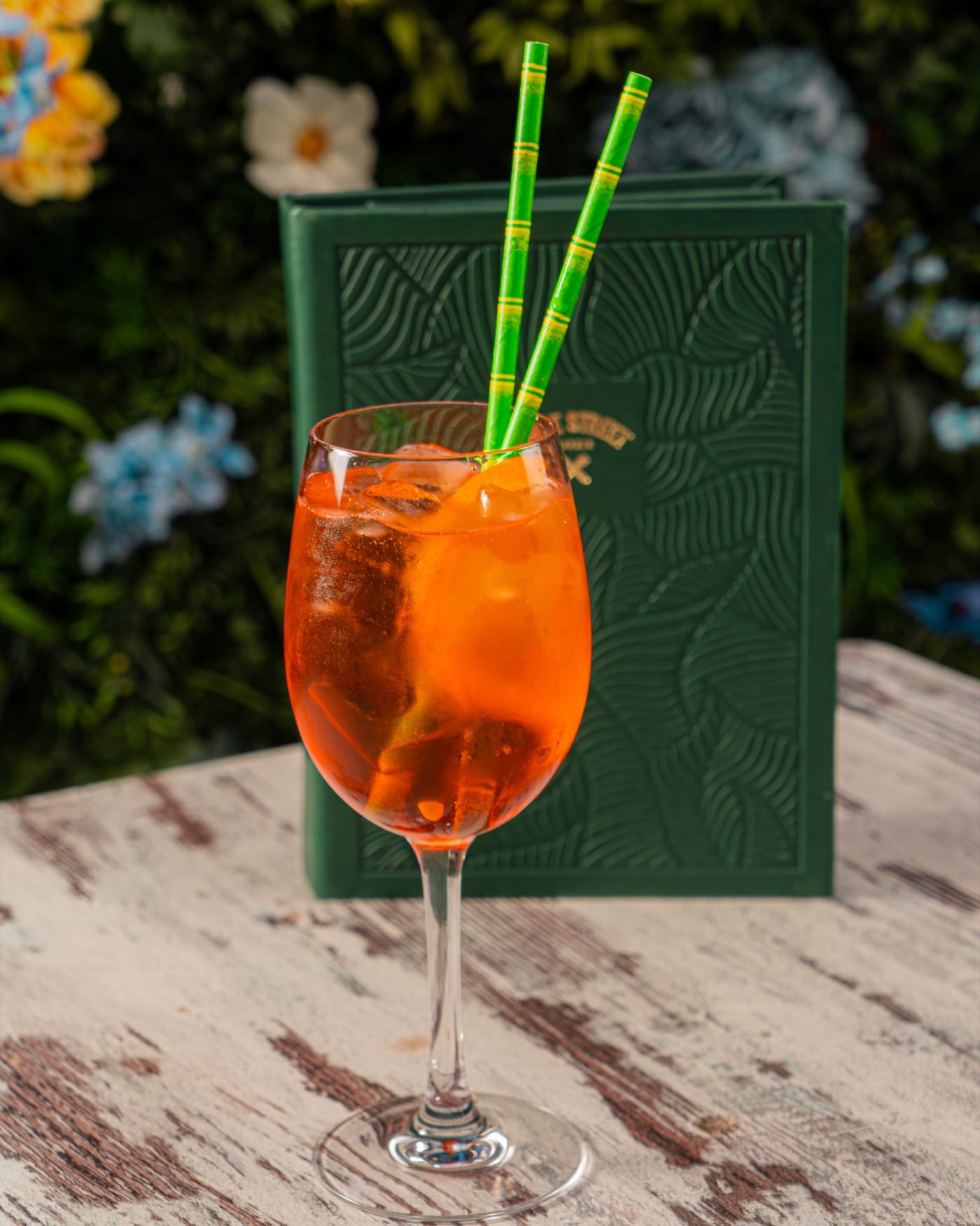 Aperol spritz with the leaf-embossed menu at Rose Street Garden, Edinburgh