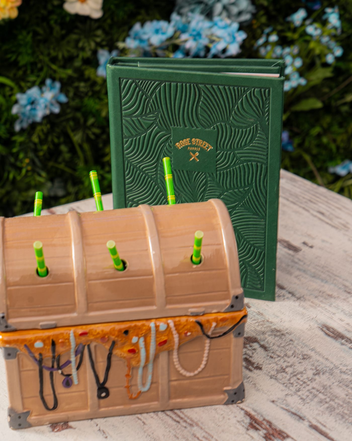Treasure chest sharing cocktail with straws at Rose Street Garden, Edinburgh