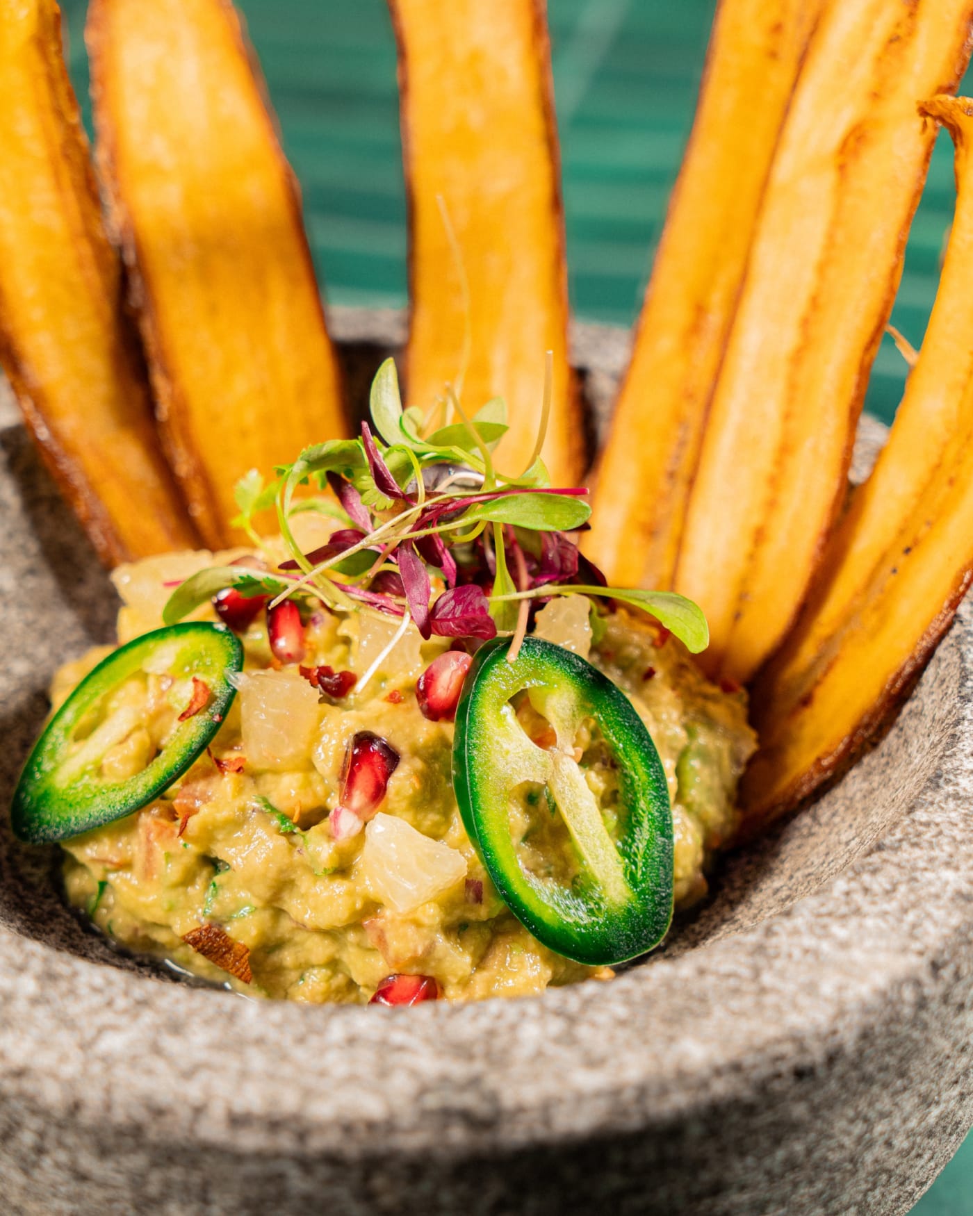 Guacamole with plantain chips in a stone molcajete at Rose Street Garden, Edinburgh