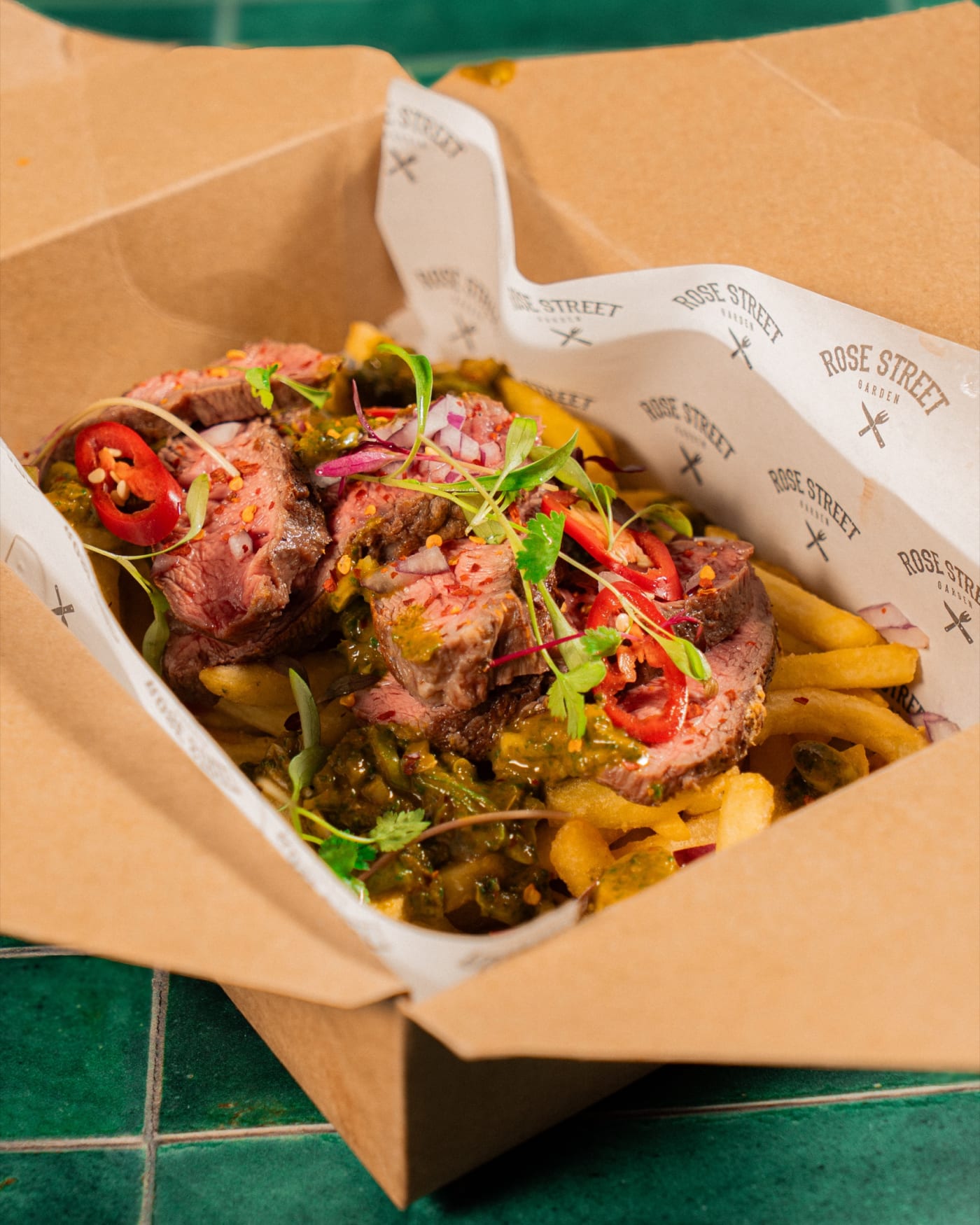 Steak-loaded fries in a branded box at Rose Street Garden, Edinburgh