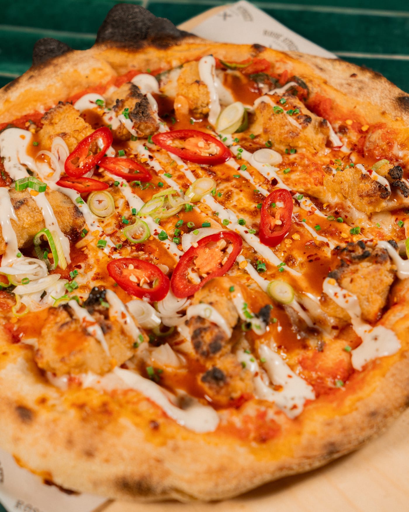 Wood-fired chicken and chilli pizza close up at Rose Street Garden, Edinburgh