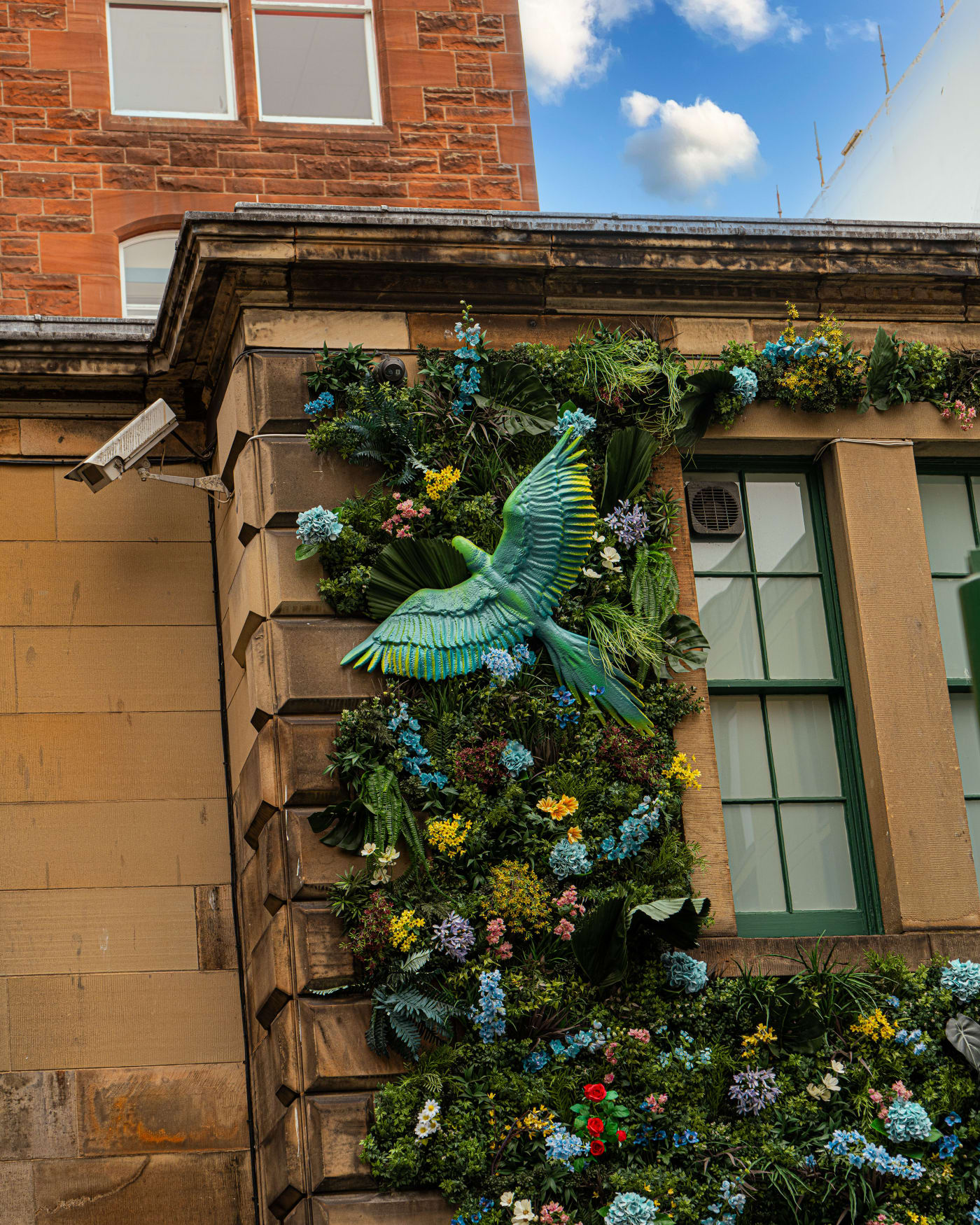 Flower-covered facade at the entrance of Rose Street Garden, Edinburgh