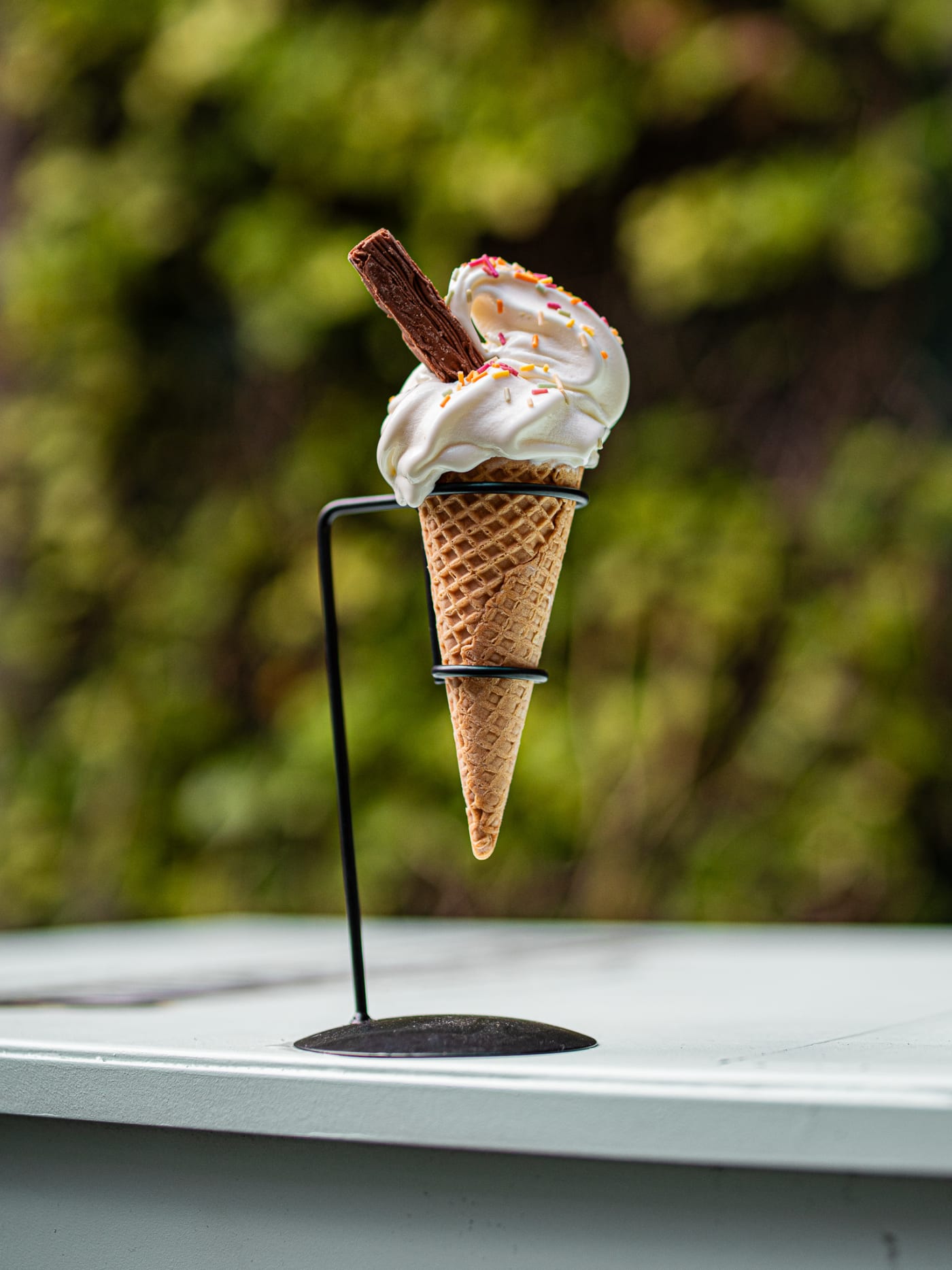 Soft serve ice cream with a chocolate flake on its stand at Rose Street Garden, Edinburgh