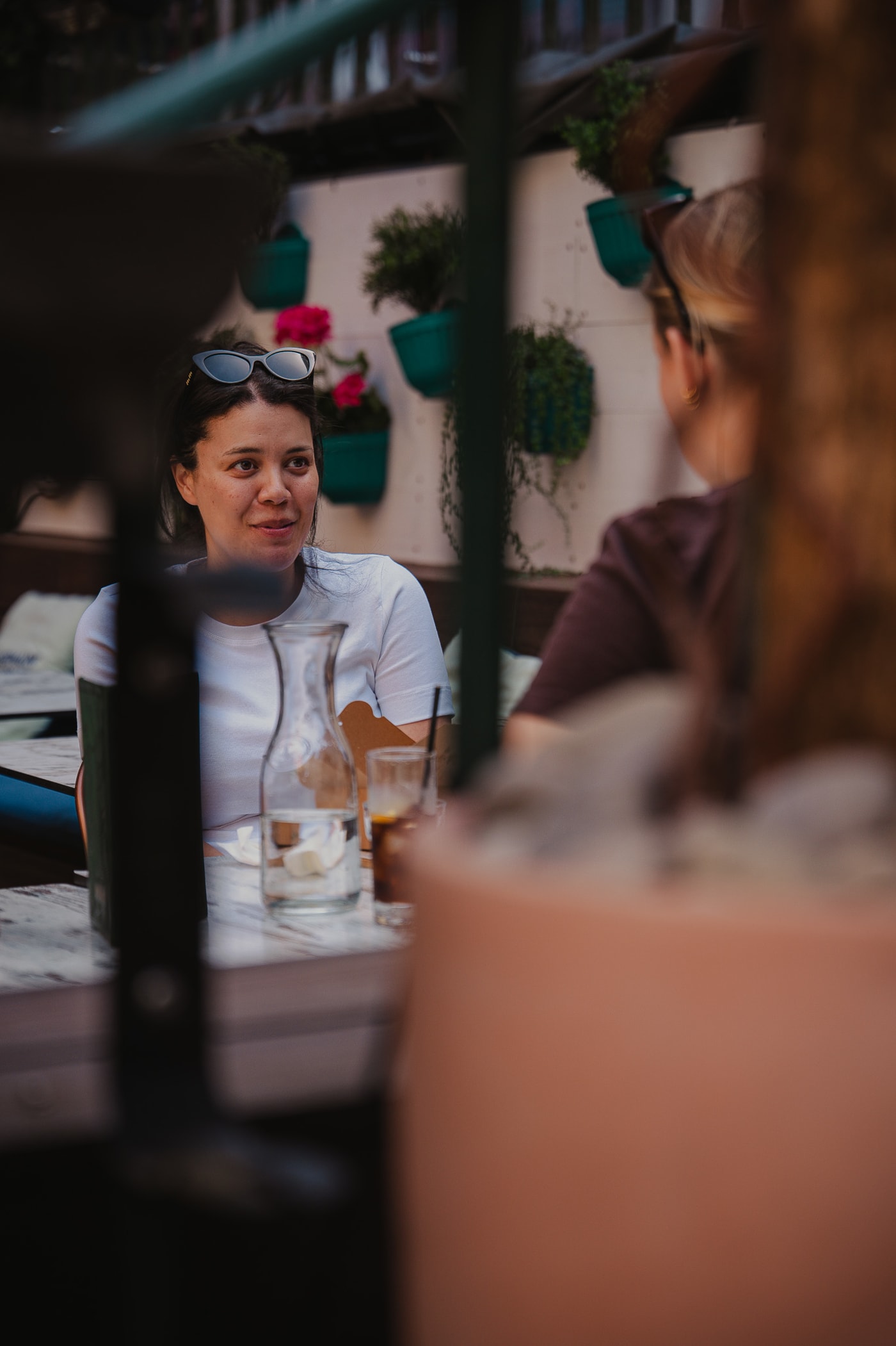 Guests sharing drinks at a garden table at Rose Street Garden, Edinburgh