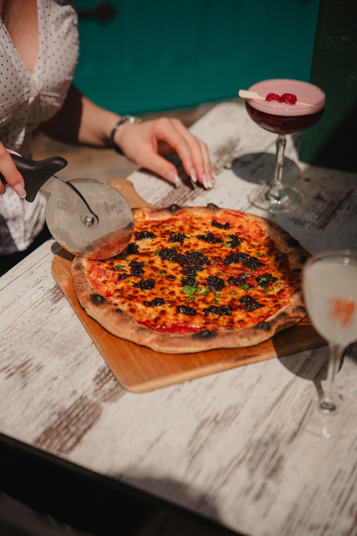 Pizza and cocktails on a sunlit garden table at Rose Street Garden, Edinburgh